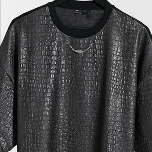 Black pleather with crocodile motif decorated with a silver chain at neckline.